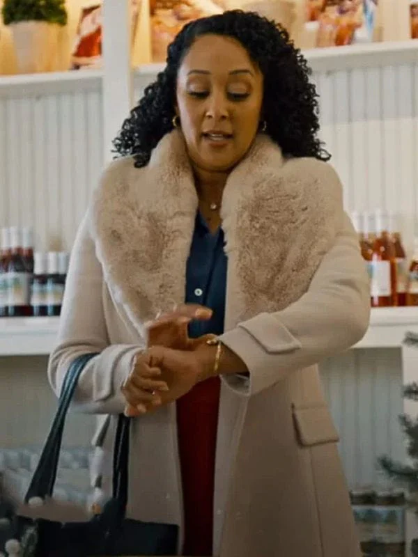tamera-mowry-housley-scouting-for-christmas-shearling-coat-1161621593.webp